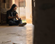 Substance abuse, young man injecting drug with syringe